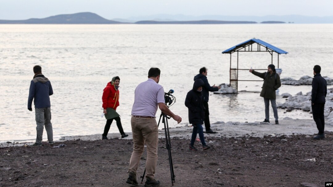 FILE - Journalists visit the shrinking salt lake of Urmia, whose receding shoreline is considered one of the worst ecological disasters of the past 25 years, in northwestern Iran, Dec. 8, 2018.