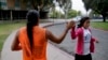 Native American students high fiving as they pass one other at the University of California, Riverside, June 26, 2014. 