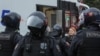 FILE - Russian law enforcement officers surround a person during a rally, after opposition activists called for street protests against the mobilization of reservists ordered by President Vladimir Putin, in Moscow, Sept. 24, 2022.