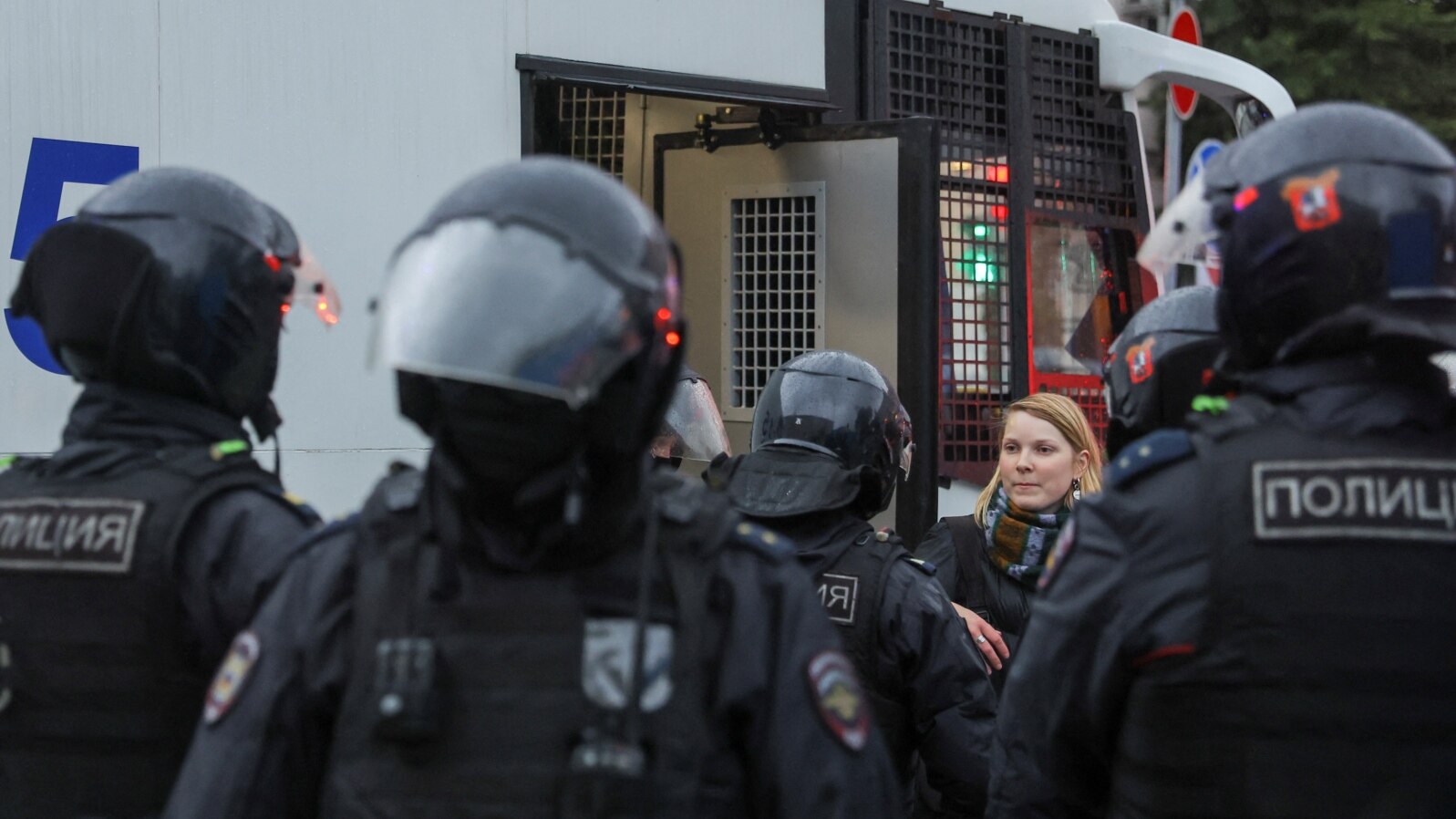 FILE - Russian law enforcement officers surround a person during a rally, after opposition activists called for street protests against the mobilization of reservists ordered by President Vladimir Putin, in Moscow, Sept. 24, 2022.