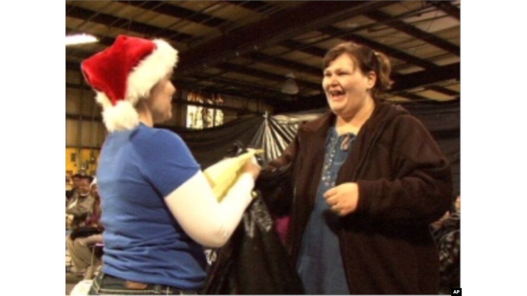 After submitting their holiday requests, families pick up presents and necessities from the Angel Tree warehouse. Tia McCoy asked for basic necessities for her son and daughter.