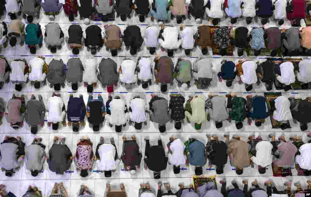 Muslim men perform an evening prayer called 'tarawih' marking the first evening of Ramadan despite concerns of the new coronavirus outbreak at the Islamic Centre Mosque in Lhokseumawe, Aceh province, Indonesia.