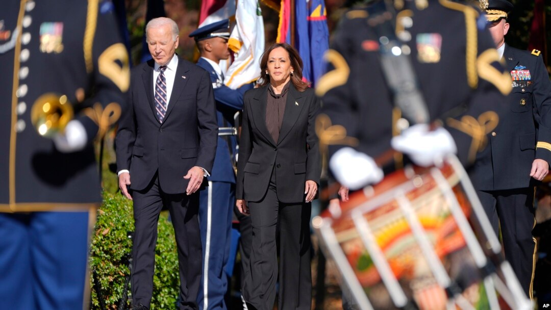 President Joe Biden, left, and Vice President Kamala Harris arrive at a wreath laying ceremony at the Tomb of the Unknown Soldier during a Veterans Day observance at Arlington National Cemetery in Arlington, Virginia, Nov. 11, 2024.