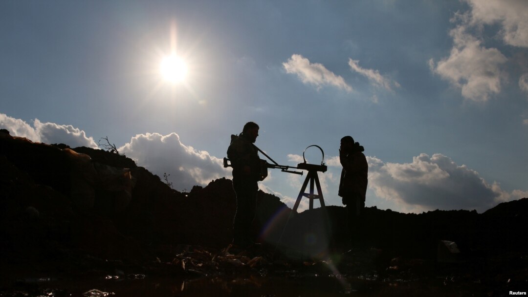 Free Syrian Army fighters stand in the east of the rebel-held town of Dael, in Deraa Governorate, Syria, Jan. 3, 2017.