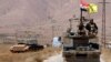 Hezbollah and Syrian flags flutter on a military vehicle in Western Qalamoun, Syria, Aug, 28, 2017.