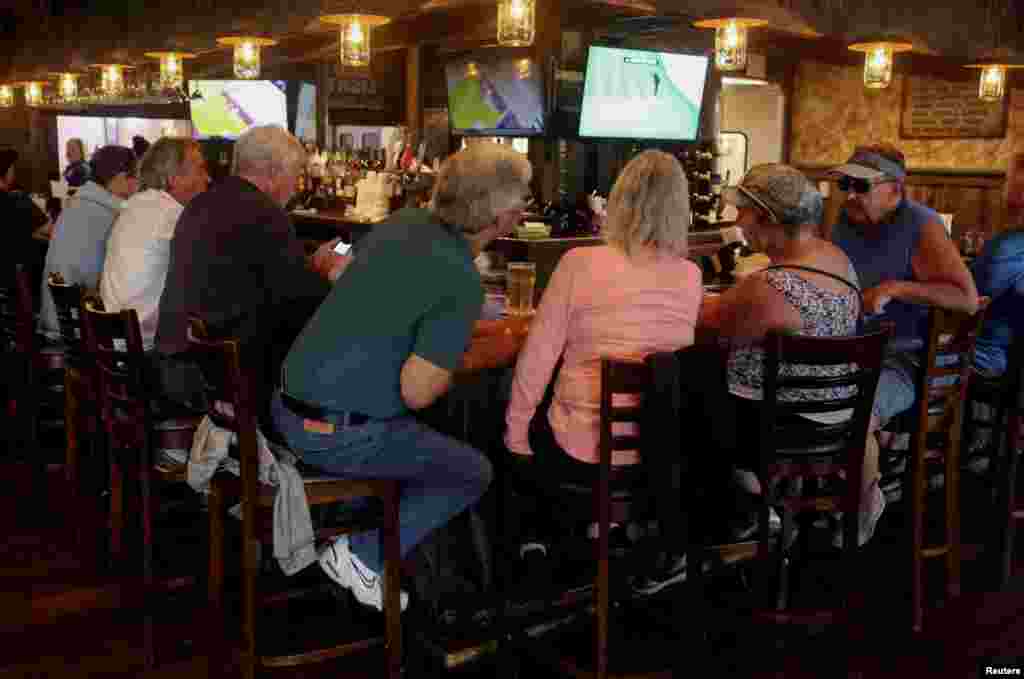 A crowd gathers at McCall's Tavern at Spanish Springs Town Square, amid coronavirus (COVID-19) cases in The Villages, Florida, March 16, 2020.