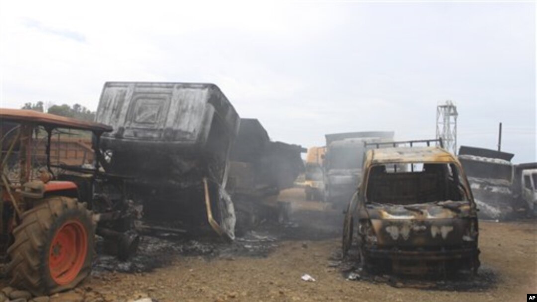 Trucks allegedly burned by communist rebels seen at the compound of Taganito Mining Corp, partly owned by a Japanese company, in Surigao del Norte province, southern Philippines on Tuesday Oct. 4, 2011.