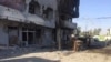 FILE - An Iraqi soldier inspects one of the damaged buildings after clashes between Iraqi security forces and members of the Islamic state in the city of Kirkuk, 180 miles (290 kilometers) north of Baghdad, Iraq, Oct, 22, 2016. 
