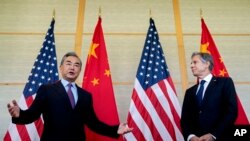 U.S. Secretary of State Antony Blinken, right, and China's Foreign Minister Wang Yi attend a meeting in Nusa Dua on the Indonesian resort island of Bali, July 9, 2022.