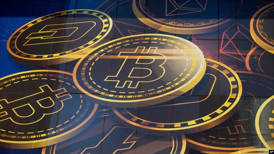 FILE - An advertisement of Bitcoin, one of the cryptocurrencies, is displayed on a building in Hong Kong, Nov. 18, 2021. Bitcoin and other cryptocurrencies were collapsing in price, June, 13, 2022 after the major crypto lender Celsius halted all withdrawa