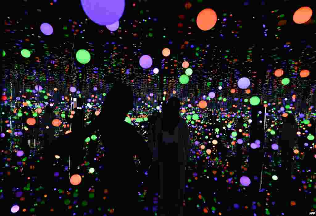 Visitors tour an art installation by Japanese artist Yayoi Kusama entitled "Infinity Mirrored Room - Brilliance of the Souls" - at the Museum MACAN (Modern and Contemporary Art Museum) in Jakart, Malaysia.