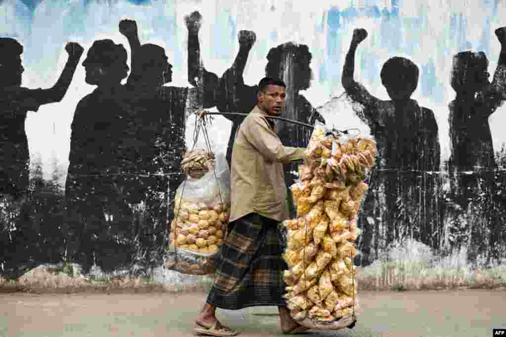 A vendor sells snacks on a street in Dhaka, Bangladesh.
