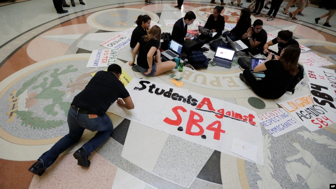FILE - Students gather in the Texas Capitol to oppose SB4, an anti-sanctuary-cities bill that seeks to jail sheriffs and other officials who refuse to help enforce federal immigration law, in Austin, Texas, April 26, 2017. The legislature passed the bill May 3, 2017.