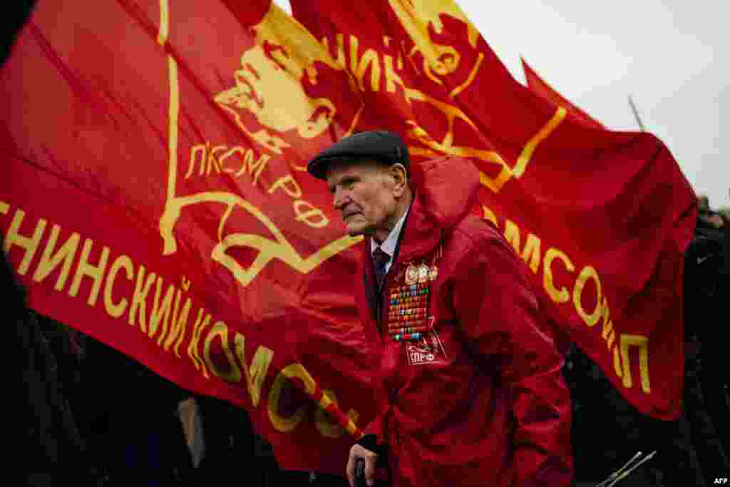 Russian Communist Party supporters take part in a memorial ceremony to mark the 96th anniversary of the death of Russian communist revolutionary Vladimir Ilyich Ulyanov, also known as Lenin, at Red Square in Moscow.