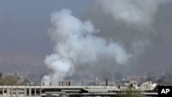 Image taken from video obtained from Shaam News Network, smoke rises from university buildings after shelling, Damascus, March 28, 2013.
