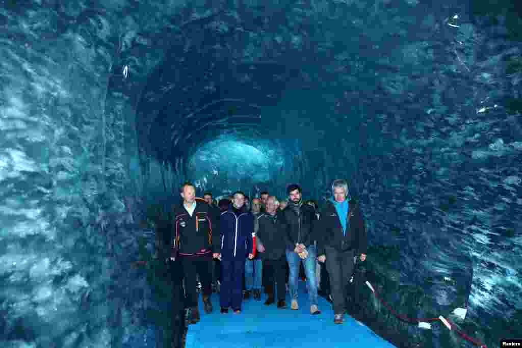 French President Emmanuel Macron, accompanied by Compagnie du Mont-Blanc CEO Mathieu Dechavanne and glaciologist Luc Moreau, visits the "Mer de Glace", the country's largest glacier, which has shrunk dramatically in recent years, in Chamonix.