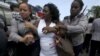 FILE - Berta Soler, leader of The Ladies in White, an opposition group, is detained by Cuban security personnel after a weekly anti-government protest march, in Havana, Sept. 13, 2015.
