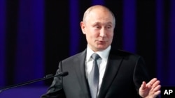 Russian President Vladimir Putin gestures as he delivers his speech during the International Forum "The development of parliamentarism" in Moscow, Russia, July 3, 2019.