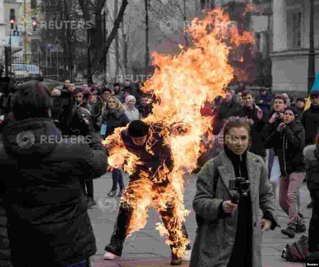 A man who called himself Oleksandr Burlakov, sets himself on fire during a protest rally outside the presidential office in Kyiv, Ukraine, to draw the attention of the authorities to his plight of the land ownership.