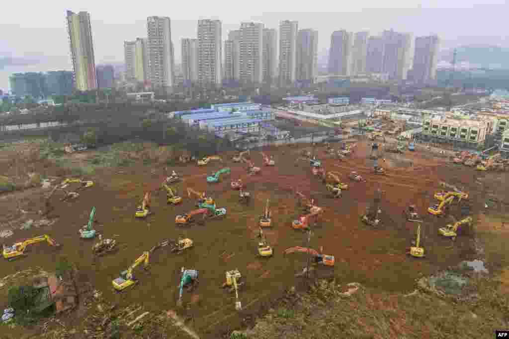 Excavators work at the construction site of a new hospital being built in a staggering 10 days to treat patients from a virus outbreak in Wuhan in China's central Hubei province.