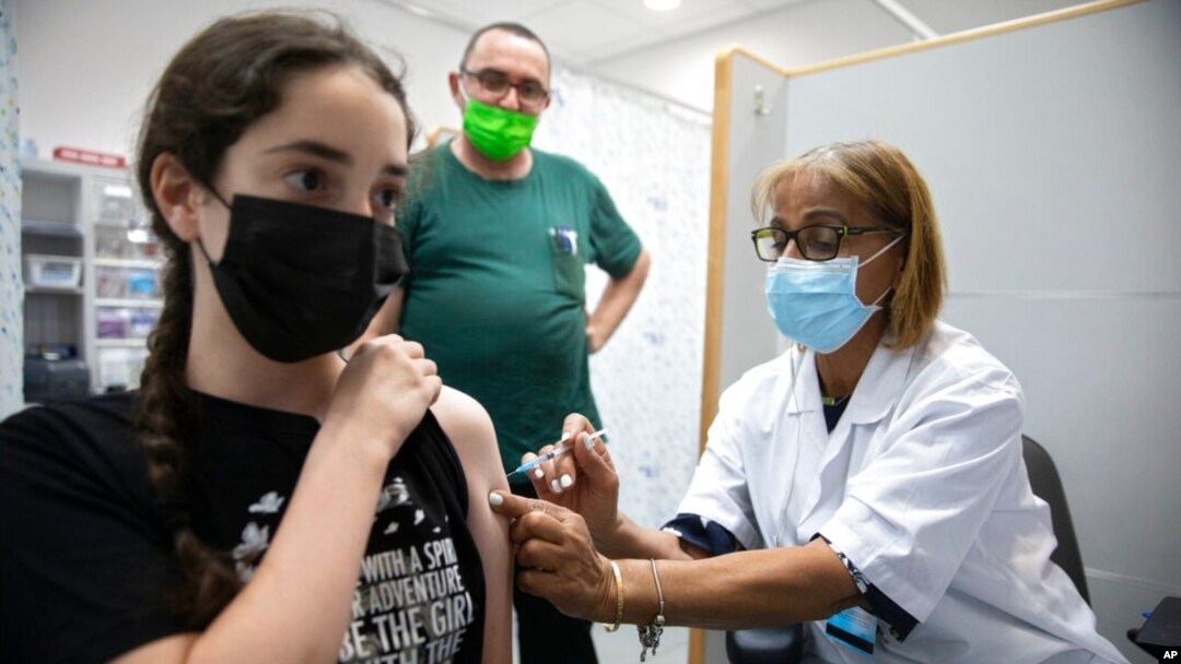 An Israeli youth receives a Pfizer-BioNTech COVID-19 vaccine in the central Israeli city of Rishon LeZion, June 6, 2021. 