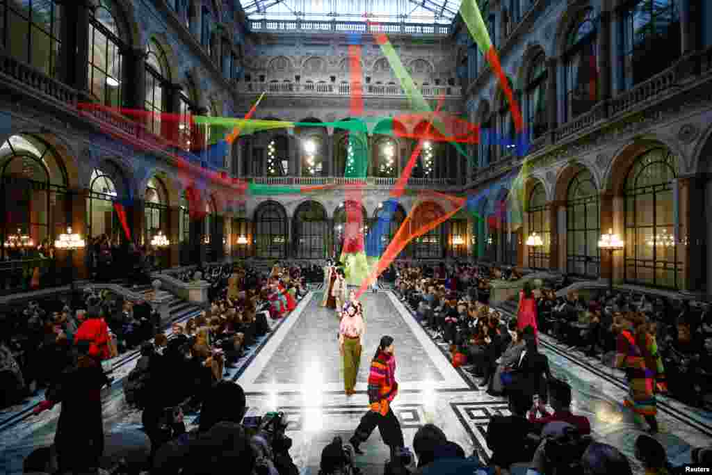 Models present creations during the Roksanda catwalk show at the Foreign & Commonwealth Office during London Fashion Week in London.