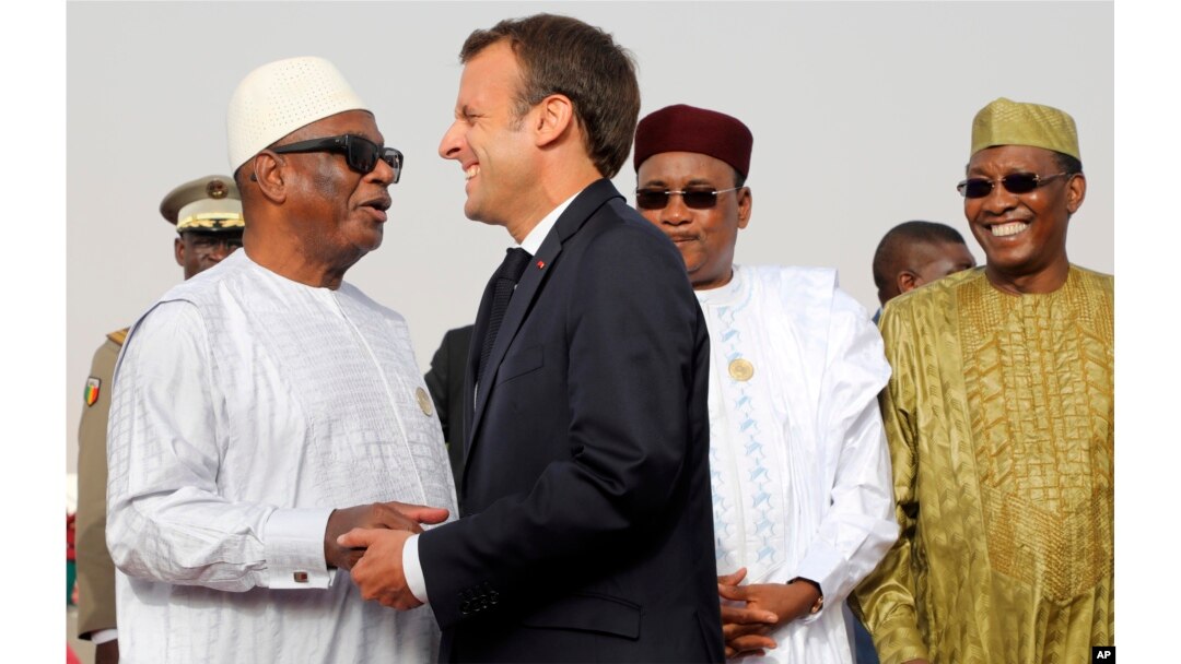 In this pictured taken July 2, 2018, French President Emmanuel Macron delivers a speech during a press conference ahead of a G5 Sahel force meeting while (left to right) Mauritania President Mohamed Ould Abdel Aziz, Niger President Mahamadou Issoufou, Mali President Ibrahim Boubacar Keita, Chad President Idriss Deby, Burkina Faso President Roch Marc Christian Kabore look on, in Nouakchott, Mauritania.
