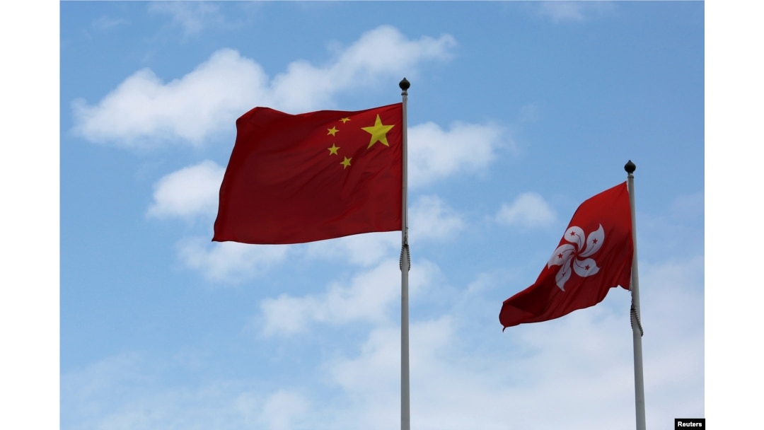 A Chinese national flag and a Hong Kong flag fly outside the Legislative Council in Hong Kong, China November 7, 2016, as China's parliament passed an interpretation of Hong Kong's Basic Law on Monday that says lawmakers must swear allegiance to the city