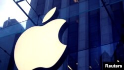 he Apple Inc. logo is seen hanging at the entrance to the Apple store on 5th Avenue
