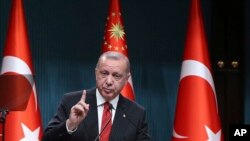 FILE - Turkey's President Recep Tayyip Erdogan speaks during a ceremony at the presidential palace, in Ankara, Turkey, May 6, 2019. 