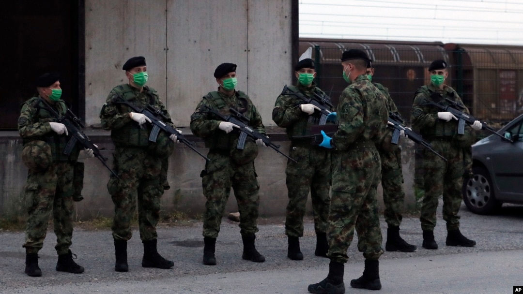 Serbian soldiers patrol around the center for refugees in Sid, about 100 kilometers west of Belgrade, Serbia, May 16, 2020. 