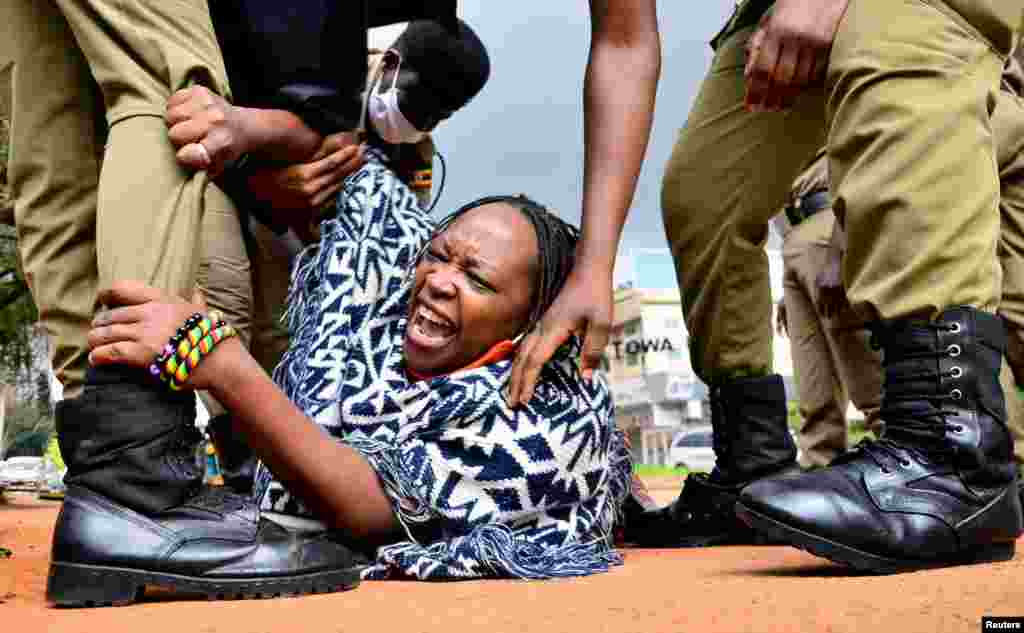 Ugandan academic Stella Nyanzi reacts as police officers detain her for protesting against the way the government distributes the relief food and the lockdown situation to control the spread of the coronavirus disease (COVID-19) outbreak in Kampala.