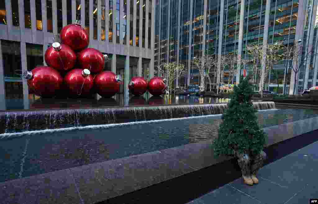 Street performer Thomas Liberto from Bel Air, Maryland, who goes by the social media name "Mr. Christmas Tree," sits by Christmas decorations around midtown New York, Dec. 19, 2019.