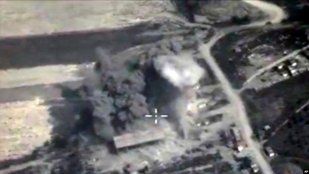 In this photo made from the footage taken from Russian Defense Ministry official web site on Sunday, Oct. 4, 2015, an aerial view of a bomb explosion in Syria.