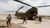 FILE - U.S. troops walk from a Chinook helicopter in Uruzgan province, Afghanistan, July 7, 2017. 