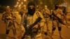 FILE - A still image taken from an Islamic State video released through the group's Amaq news agency shows an unidentified militant addressing the camera. The video was said to have been shot in Mosul, Iraq, on Oct. 18, 2016.