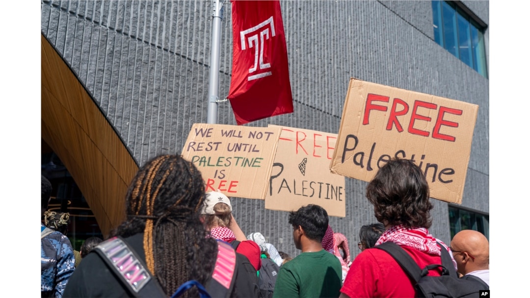 People hold up signs during a pro-Palestine rally and march on Temple University campus in Philadelphia, Pennsylvania, Aug. 29, 2024.