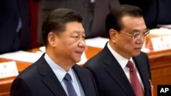 資料照：中國國家主席習近平與總理李克強在北京人大會堂出席全國人大會議閉幕式。 （2019年3月15日）