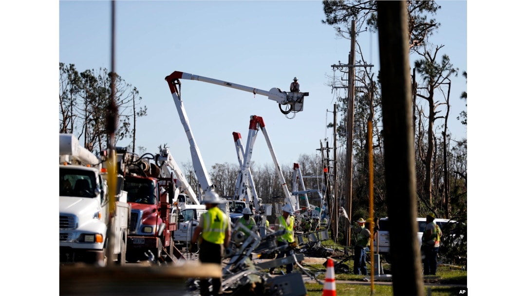 Crews work to restore power in the aftermath of Hurricane Michael in Panama City, Fla., Oct. 13, 2018.