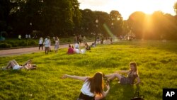 People enjoy the warm weather at Gorky Park during sunset in Moscow, Russia, June 7, 2020, as the authorities have eased the tight lockdown restrictions introduced in late March, due to the outbreak of coronavirus.