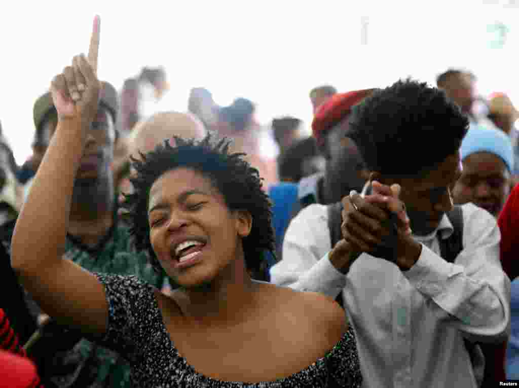 Students sing struggle songs during a gathering as academic staff and church leaders protest demanding free tertiary education at Johannesburg's University of the Witwatersrand, South Africa.