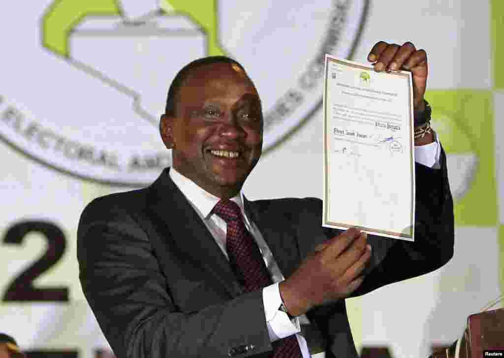 President-elect Uhuru Kenyatta displays the certificate from Independent Electoral and Boundaries Commission (IEBC) declaring him the winner of the country's presidential election in Nairobi, Mar. 9, 2013.
