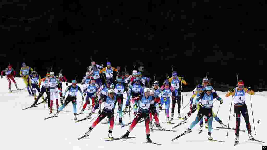 Marte Olsbu Roeiseland of Norway, center, leads during the women's 12.5 km mass start competition at the Biathlon World Championships in Antholz, Italy.