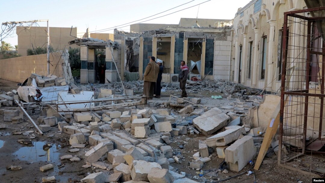 People gather at the site of a bombing in the city of Ramadi, west of Baghdad, Iraq, Nov. 6, 2014.