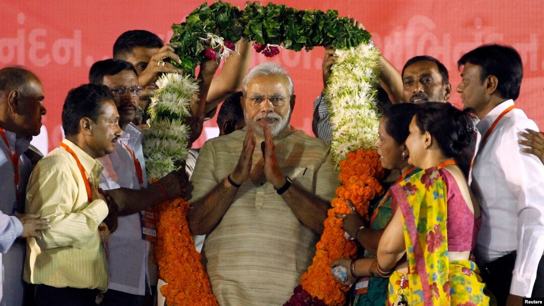 Hindu nationalist Narendra Modi, who will be the next prime minister of India, wears a garland presented to him by his supporters at a public meeting in the western Indian city of Ahmedabad, May 20, 2014