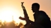FILE - A fighter from the Kurdish People Protection Unit (YPG) is seen at sunset in the Syrian town of Ain Issi, near Raqqa, July 10, 2015. Turkmen commander Abdulsettar al-Jaddir was killed on the day he became chairman of a local military council aligned with the YPG.