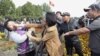 Participants fight during an opposition rally in Kyrgyzstan's capital Bishkek October 3, 2012. Police clashed with at least 2,000 opposition protesters demanding that the government nationalises the country's flagship gold venture with Canada on Wednesday