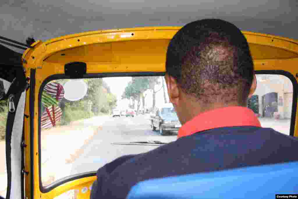 Bangi navigates the streets of Africa’s commercial hub at a bracing maximum speed of 35 miles per hour, offering door-to-door service. (Photo by Darren Taylor)
