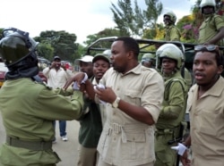 FILE - This photo taken on Jan. 5, 2011 shows Godbless Lema being arrested by an anti-riot police during a peaceful demonstration by supporters of the main opposition party Chadema.