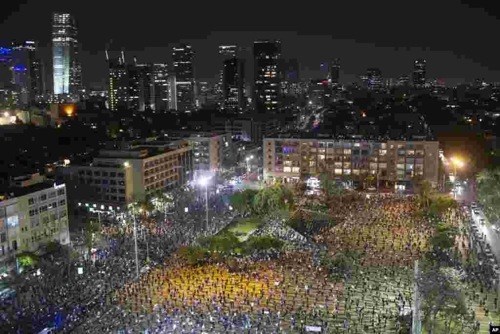 People keep social distancing amid concerns over the country's coronavirus outbreak, during a protest against Prime Minister Benjamin Netanyahu in Tel Aviv, Israel, April 19, 2020.